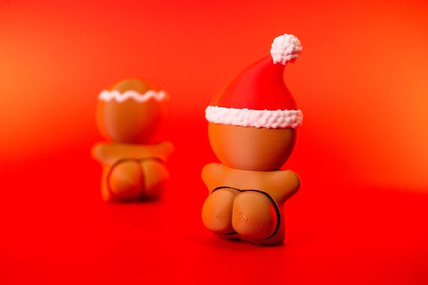 Rear view of Santa-hat gingerbread man clicker with red hat, white trim and cheeky novelty detail