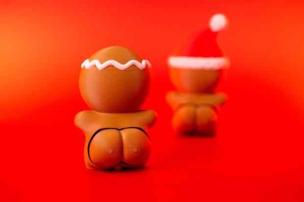 Rear view of Gingerbread Man Clicky Ass Christmas fidget with white icing-style head trim and cheeky clicker detail