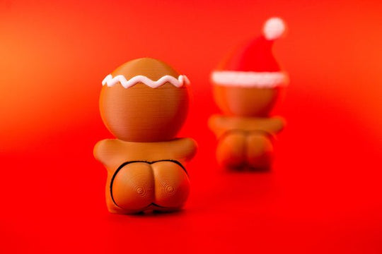 Rear view of Gingerbread Man Clicky Ass Christmas fidget with white icing-style head trim and cheeky clicker detail